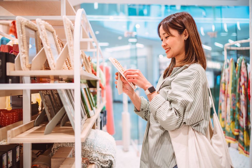 cheerful woman shopping for home decor at a stylish store