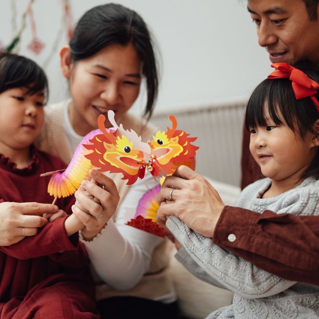 cheerful young asian family celebrating chinese new year at home