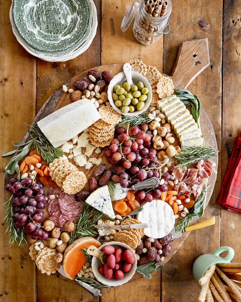 a charcuterie board with crackers cheese and fruits