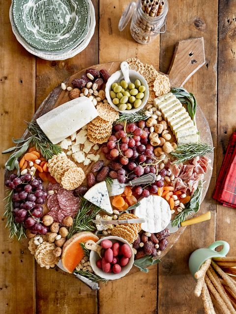 a charcuterie board with crackers cheese and fruits