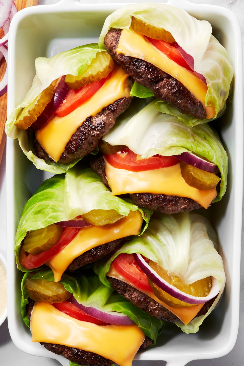 cheesburger with tomato wrapped inside cabbage