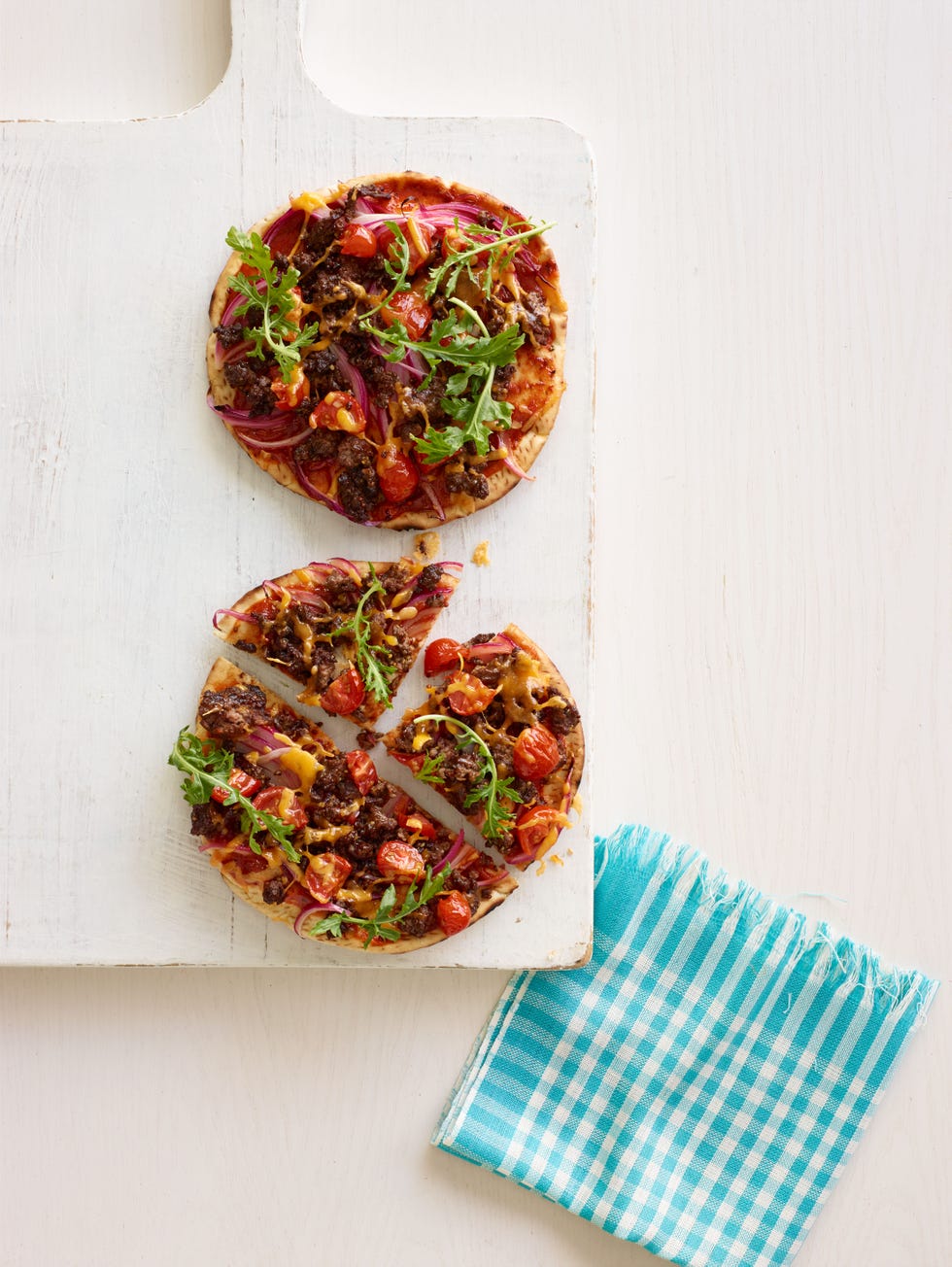 cheeseburger flatbread pizza sliced in quarters