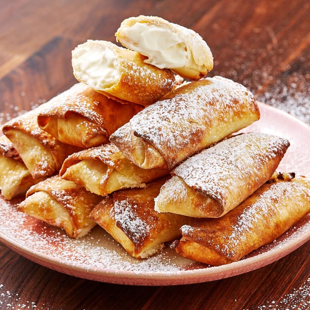 egg rolls filled with a cheesecake filling and dusted with confectioners' sugar