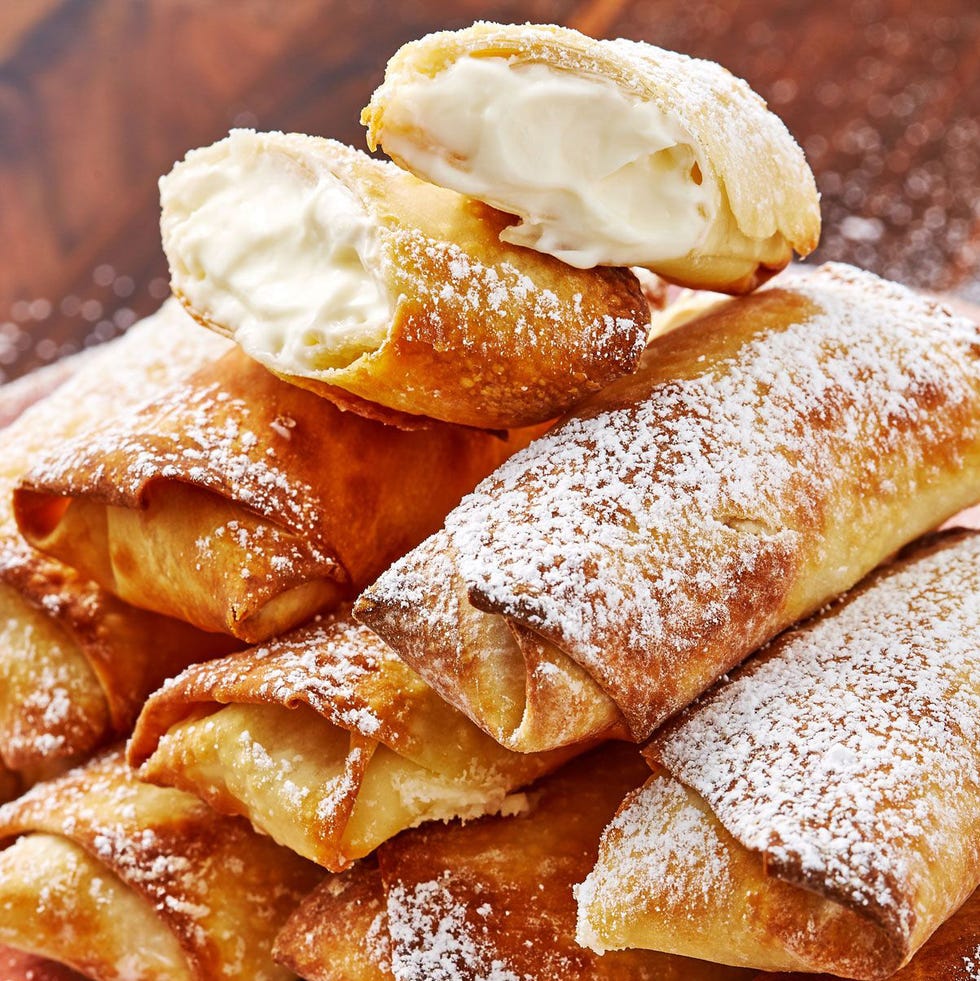 egg rolls filled with a cheesecake filling and dusted with confectioners' sugar