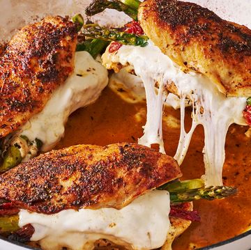 cheesy asparagus stuffed chicken in a white dutch oven