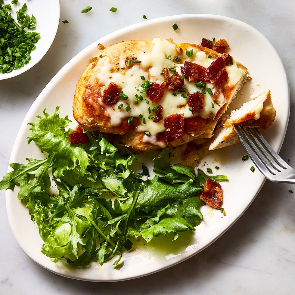 chicken breasts covered in bacon pieces and melted cheese