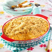 cheesy potato casserole in red and teal casserole dish