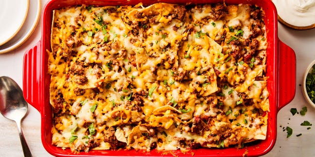 ground beef and cheese baked over chips in a casserole dish