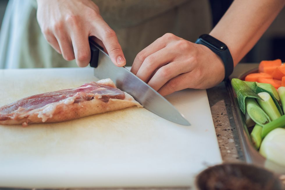 chef hands cutting meat