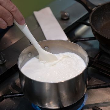 chef making make roux, creamy white sauce , bechamel in a pan