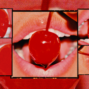 lips parted, holding a cherry between them