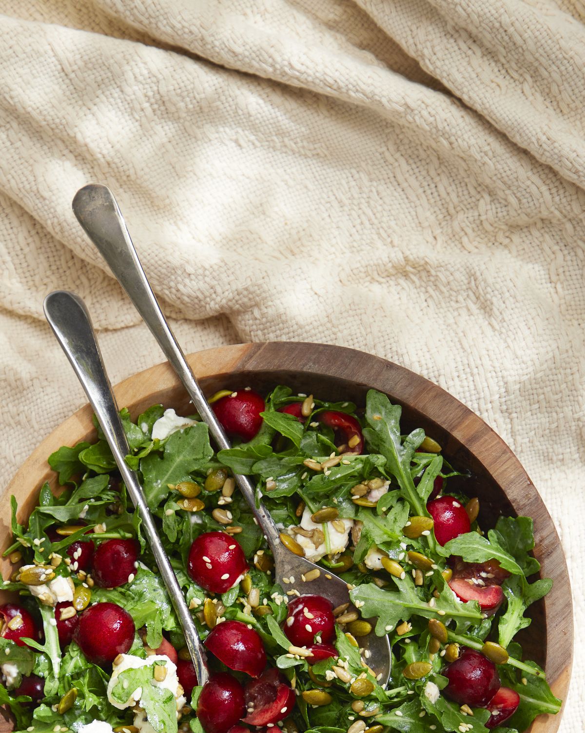 cherry, arugula, and goat cheese salad with toasted seeds