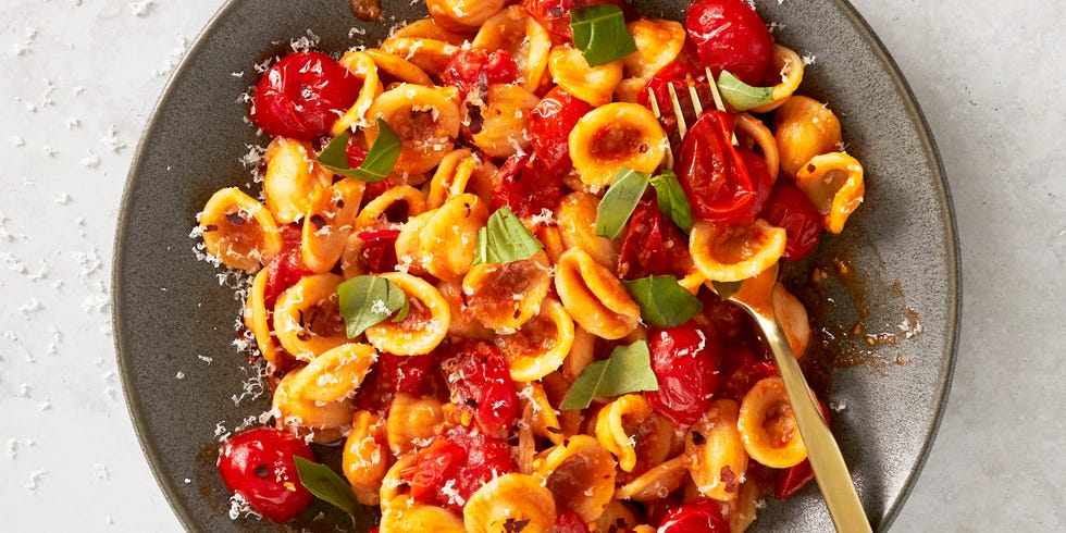 cherry tomato pasta with burst cherry tomatoes and fresh basil