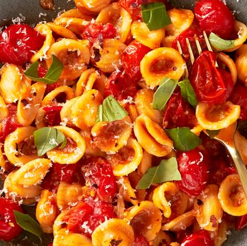 cherry tomato pasta with burst cherry tomatoes and fresh basil