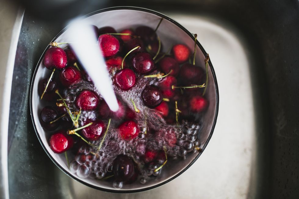 cherry washing in a sink