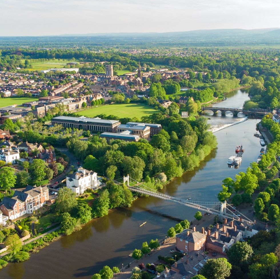 aerial view of river dee in chester at dusk including queens park bridge and the old dee bridge, cheshire, england, uk