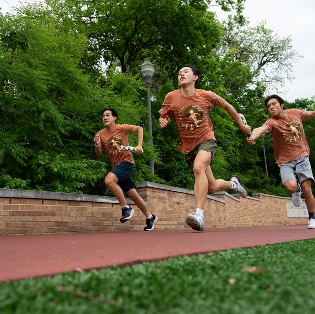 a group of people running sandal on a track