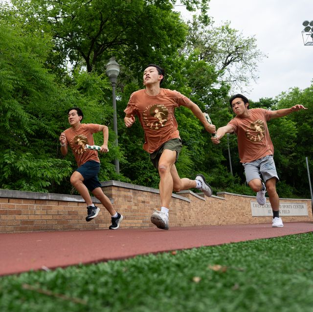 a group of people running sandal on a track