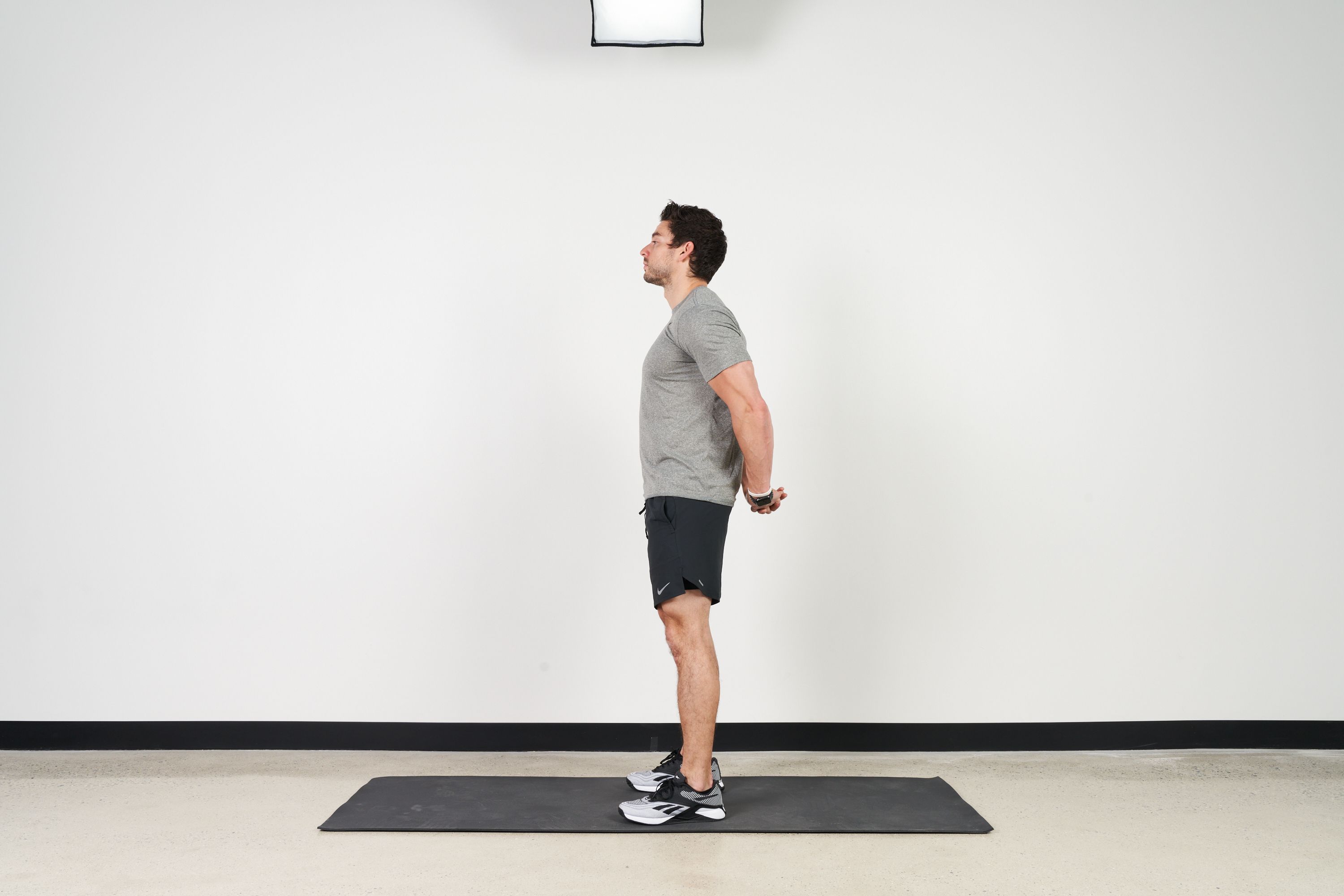 Man doing chest stretch exercise on a wall Vector Image
