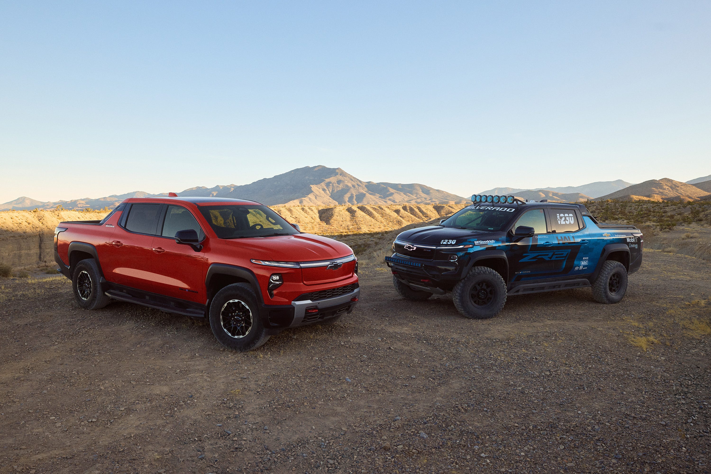 Front 3/4 view of the Chevrolet Silverado EV Trail Boss in habanero orange exterior color and silverado ev zr2 race truck concept.