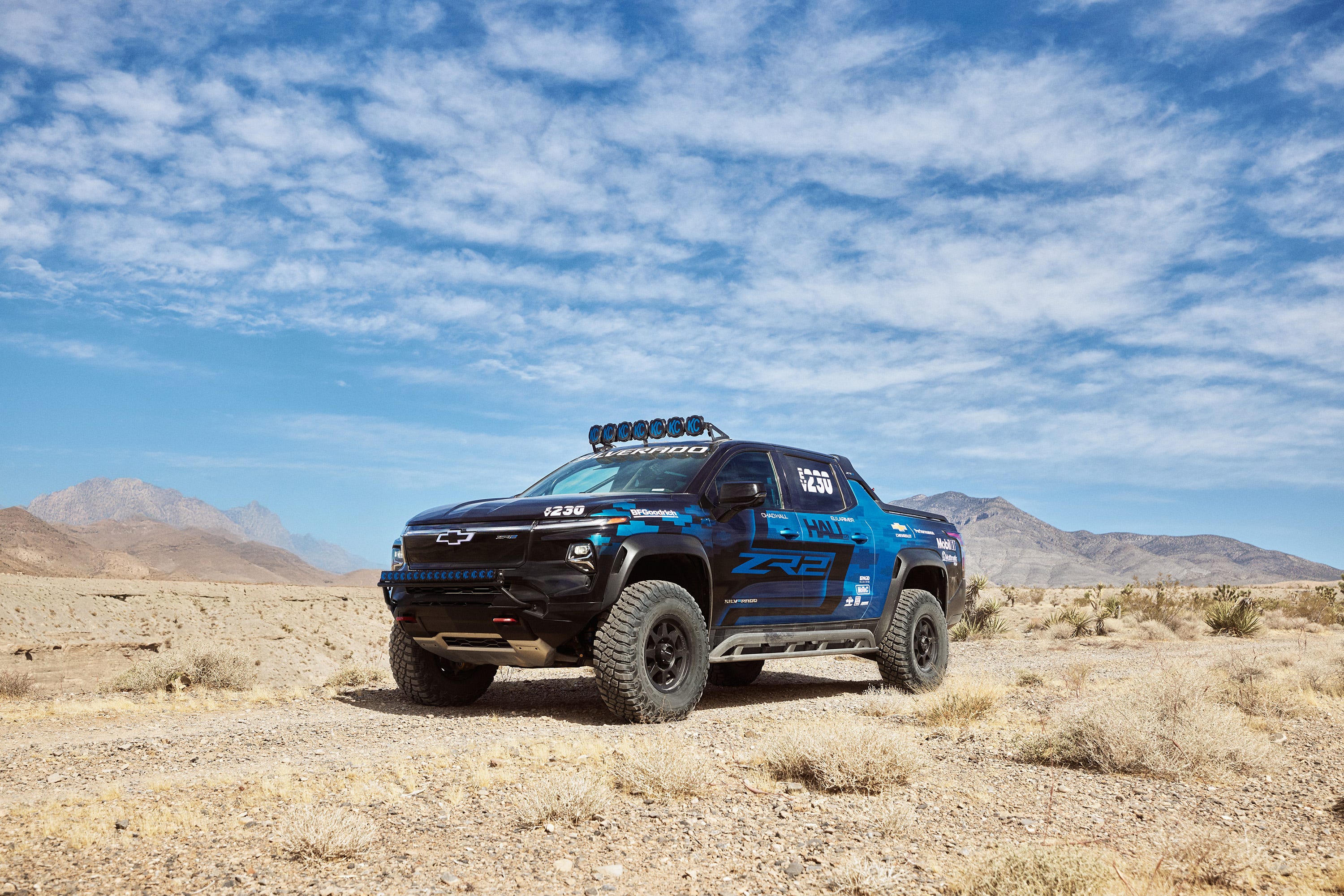 Front 3/4 view of the Chevrolet Silverado EV race truck concept parked in the desert