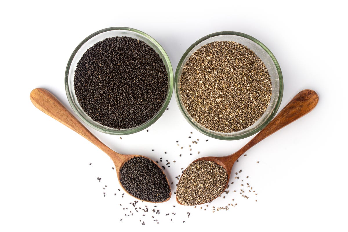 chia seeds and basil seeds in jars and spoons