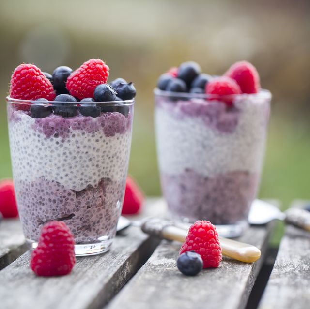 Two glasses of chia pudding with blueberries and raspberries