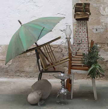 a chair and umbrella in a room