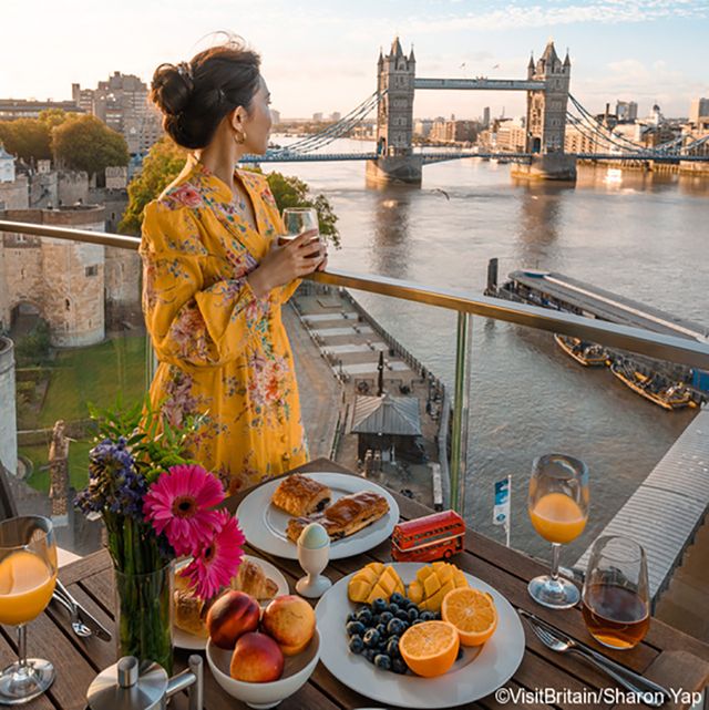 woman on rooftop terrace of cheval three quays hotel, london, england