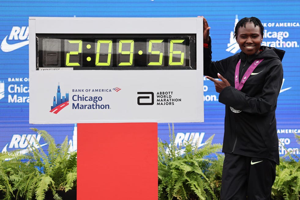 chicago, illinois october 13 ruth chepngetich of kenya poses with a clock after winning the 2024 chicago marathon professional womens division and setting a new world record with a time of 20956 at grant park on october 13, 2024 in chicago, illinois photo by michael reavesgetty images