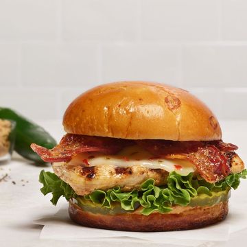 a burger with lettuce and tomato