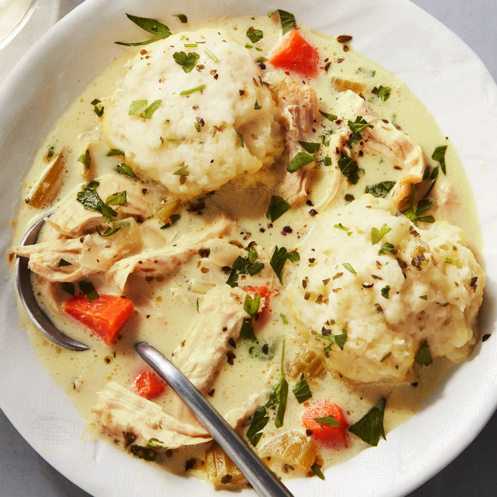 shredded chicken and dumplings in a creamy broth, topped with chopped parsley