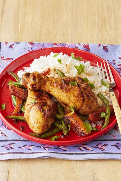 sheet pan curried chicken and rice on red plate