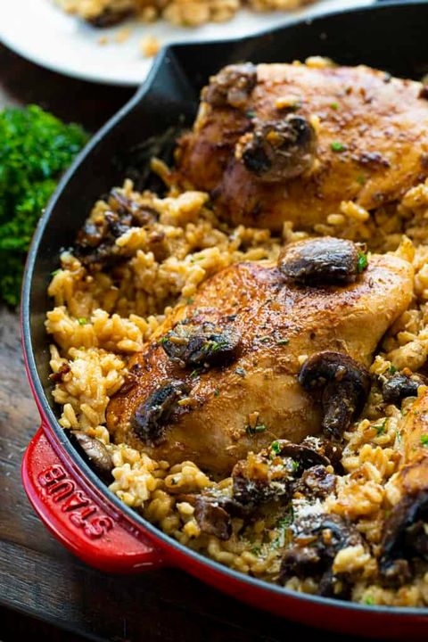 skillet chicken and mushroom risotto in red pan