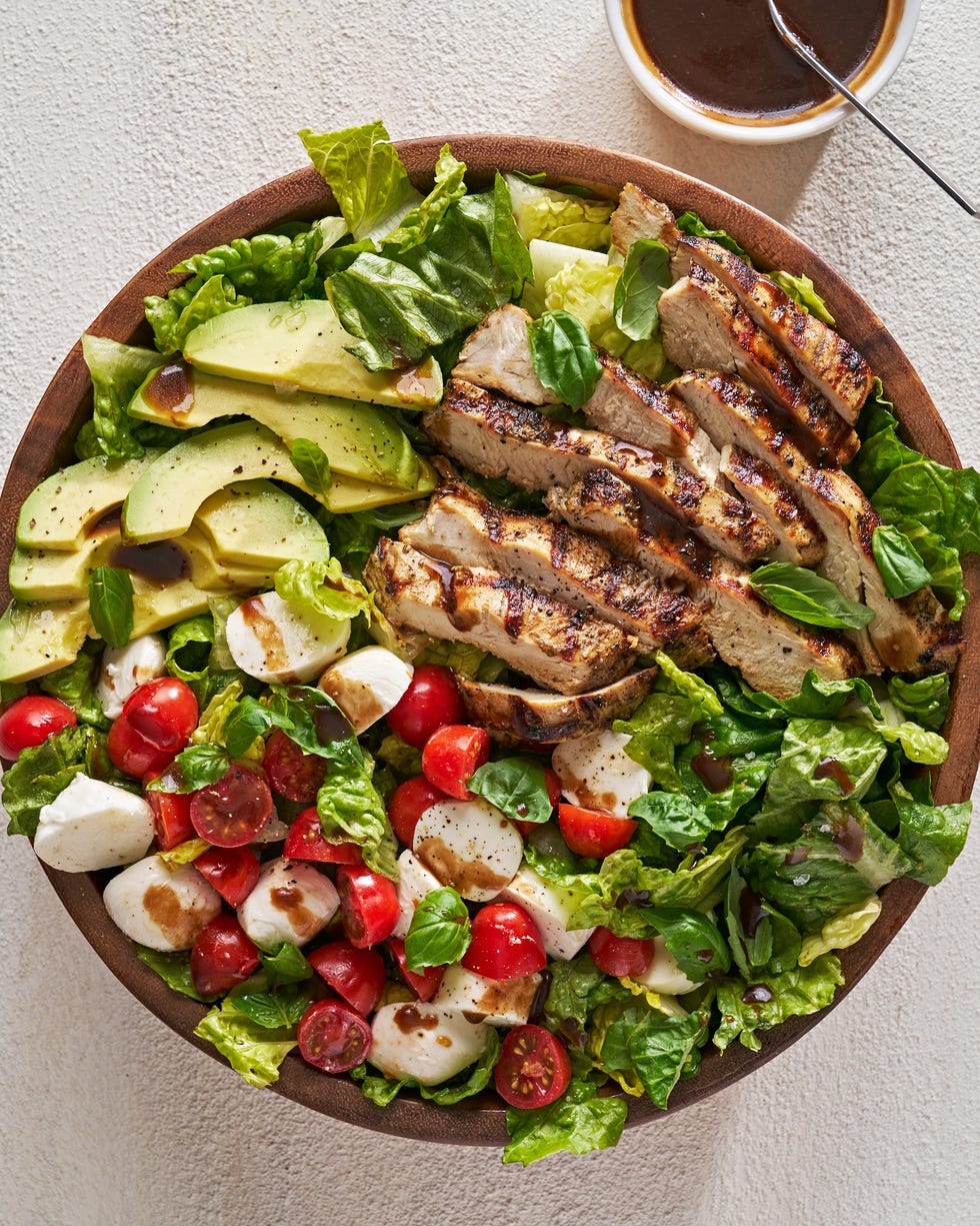 chicken avocado caprese salad in a bowl with balsamic dressing