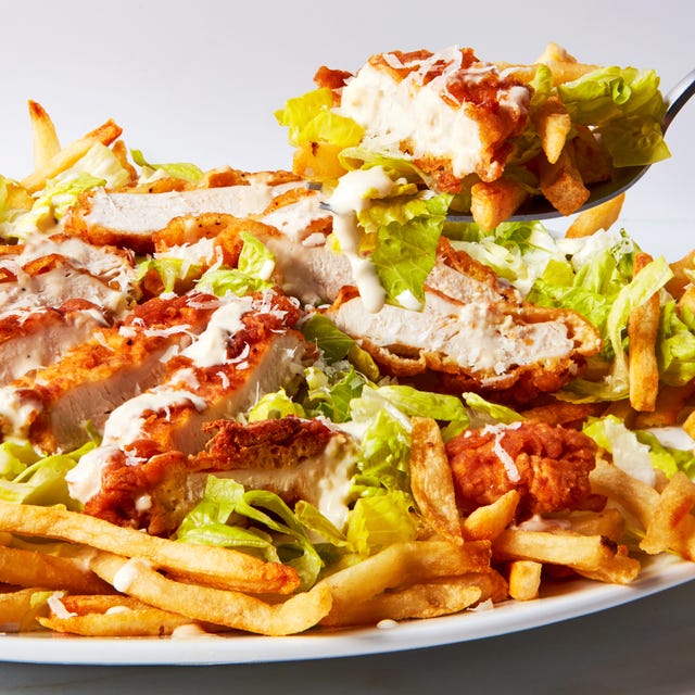 Chicken Caesar Fries caesar salad topped with fried chicken pieces over fries