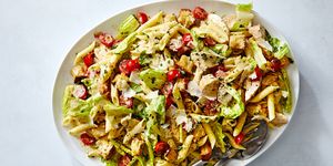 chicken caesar pasta salad with chicken, tomatoes, penne pasta, and parmesan all tossed in creamy caesar dressing