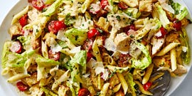 chicken pasta salad with lettuce, tomatoes, and parmesan