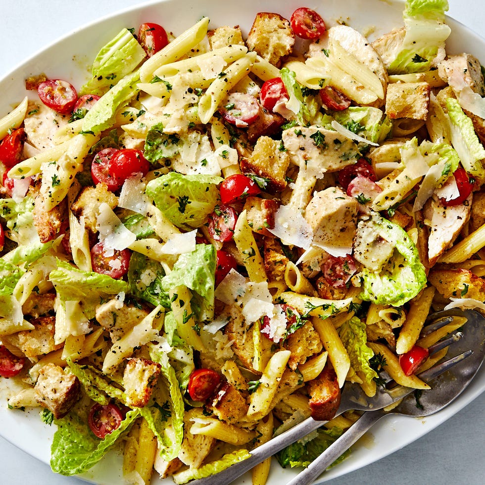 chicken pasta salad with lettuce, tomatoes, and parmesan