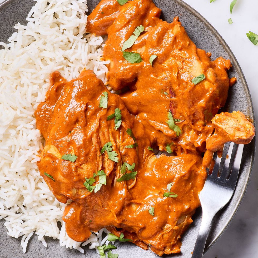 creamy chicken curry in a pan served with rice