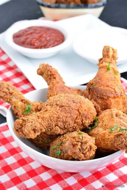 crispy fried chicken drumsticks on red checkered linen