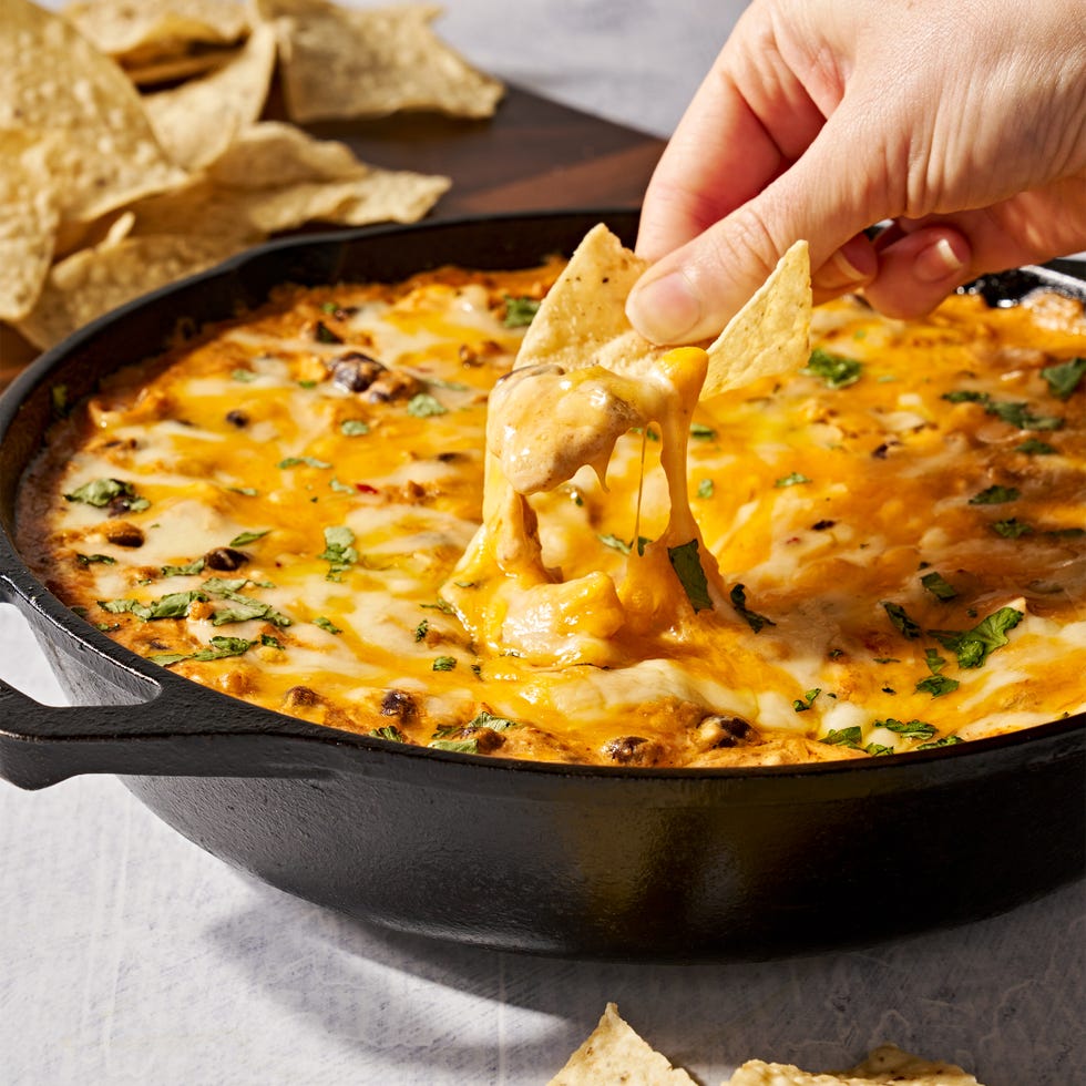 chicken enchilada dip dipped with chips