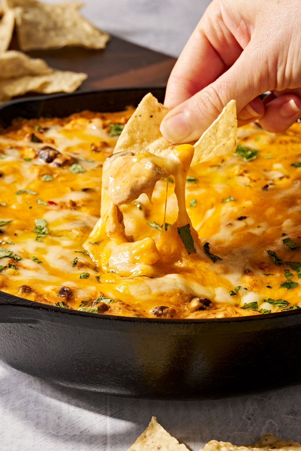 chicken enchilada dip dipped with chips
