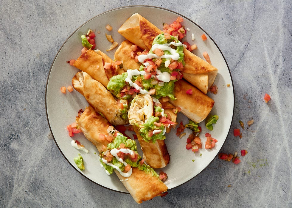 chicken flautas topped with guac and sour cream