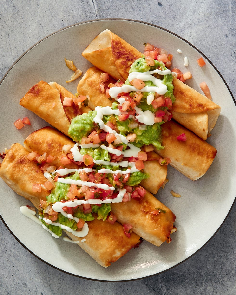 chicken flautas topped with guac and sour cream