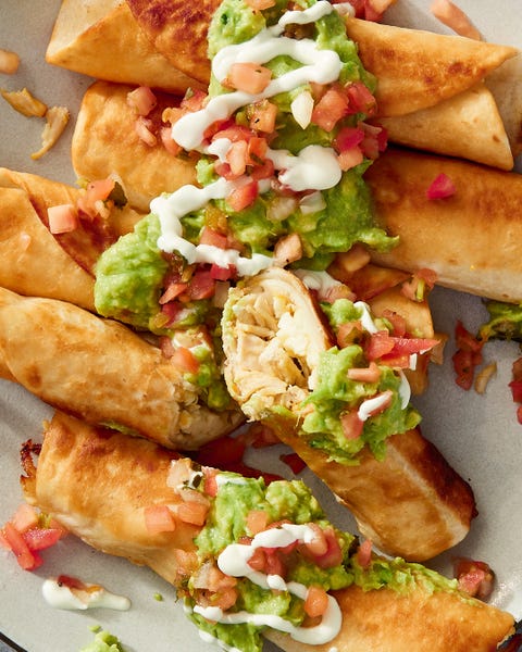 chicken flautas topped with guac and sour cream chicken flautas topped with guac and sour cream