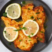 chicken francese with lemon slices and parsley