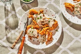 chicken fried oyster mushrooms on a white specked plate