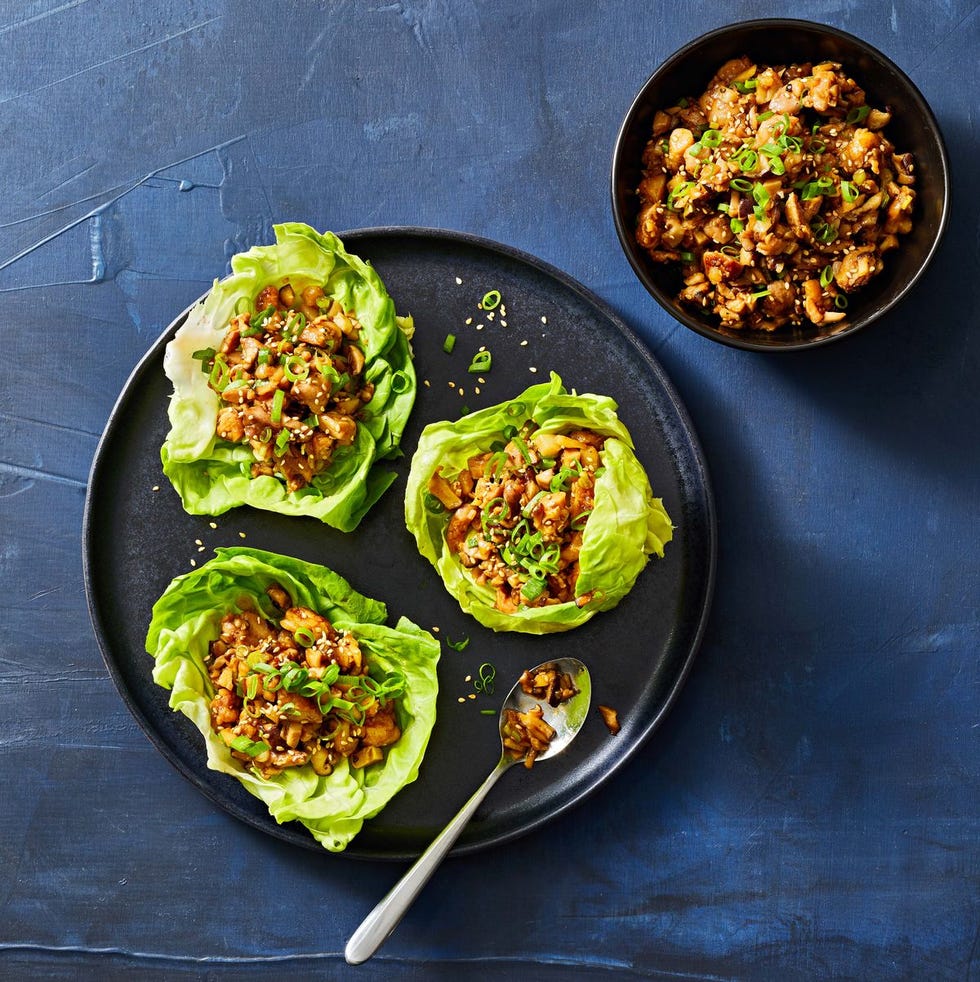 chicken lettuce wraps on a black plate
