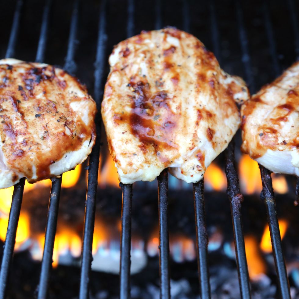 Chicken meat with barbecue sauce cooking on the grill